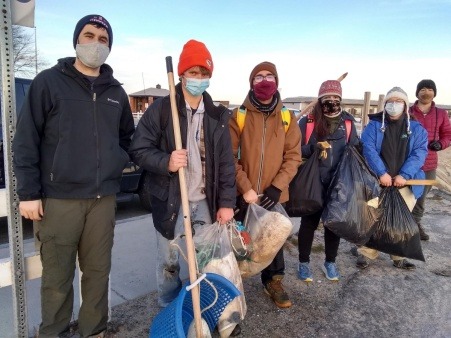 NECWA interns lined up with the marine debris they have cleaned off of a beach on Cape Cod