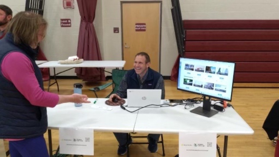 signing people up on the bright action web platform at the sustainability fair